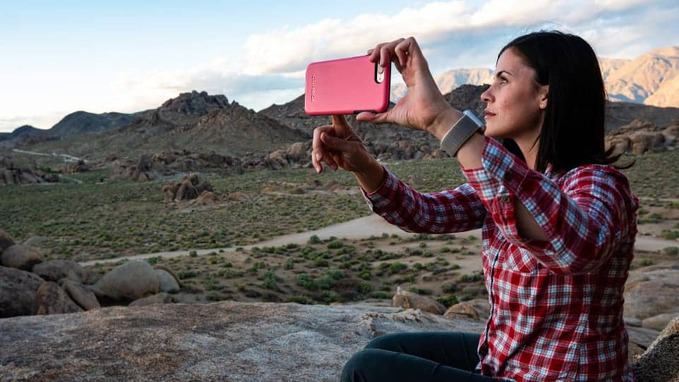 a-young-lady-taking-selfie-near-mountains