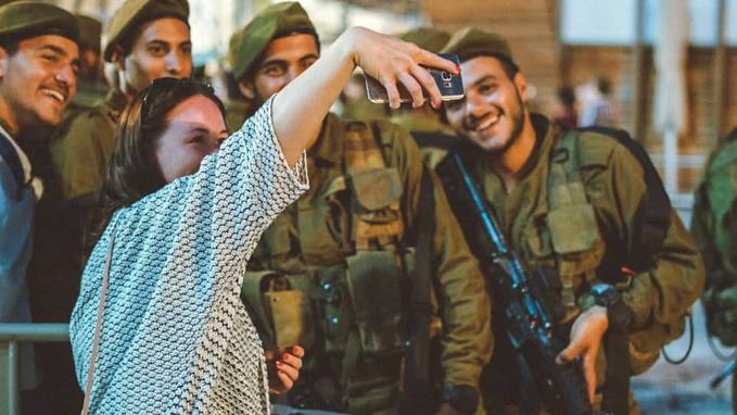 girl-taking-selfie-with-army-people